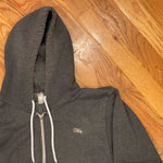 Teenbeat enamel pin on a hooded sweatshirt