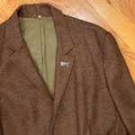 Teenbeat enamel pin on a sportscoat